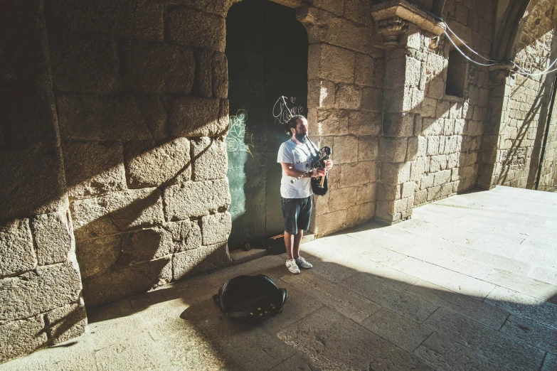 the man is holding his baseball bat and wearing a helmet