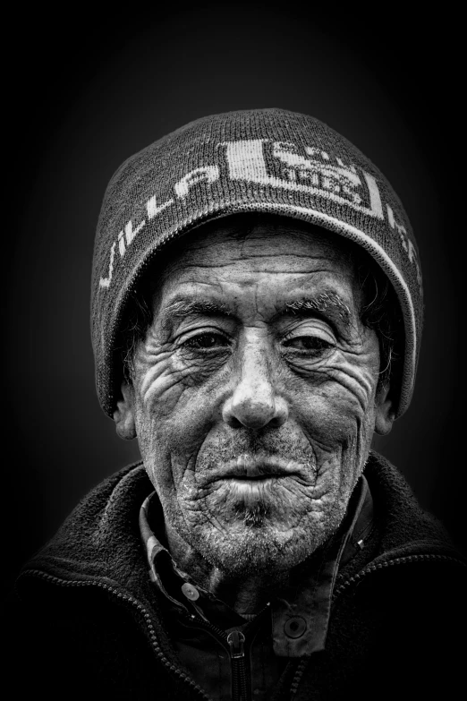 black and white pograph of an old man wearing a beanie