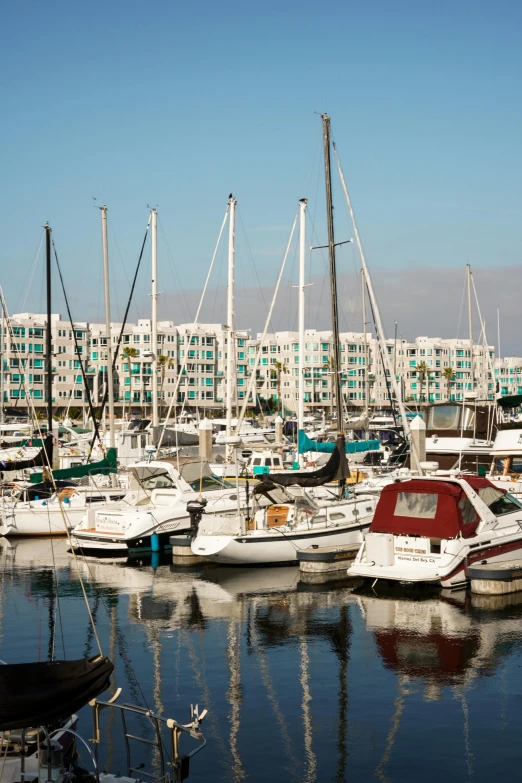 some sail boats are docked at the marina