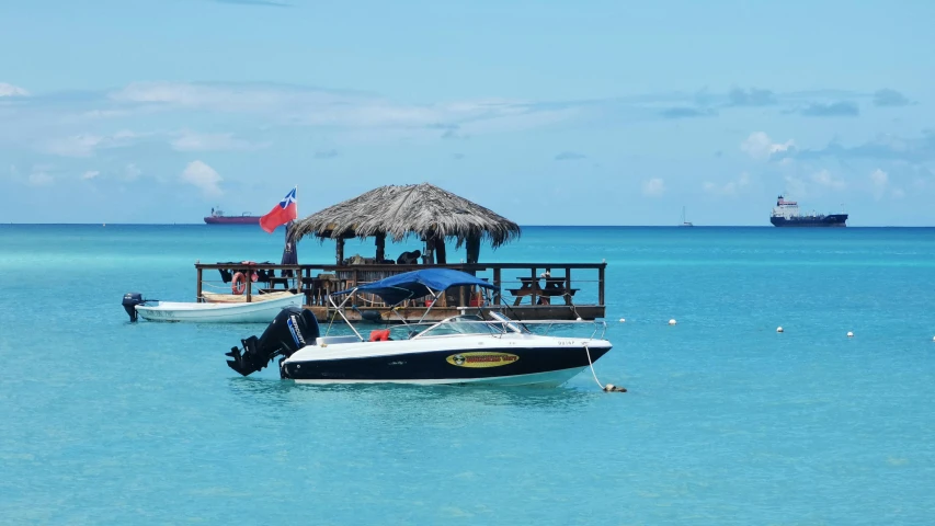 a boat with people hanging out of it in a large ocean