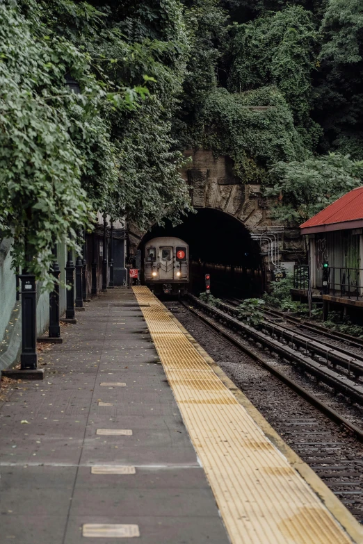 a train is coming out of a tunnel