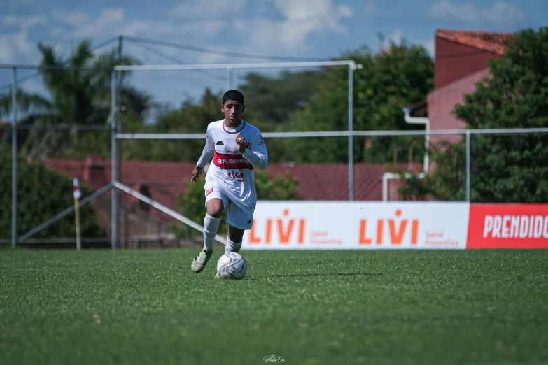 the soccer player is running with the ball