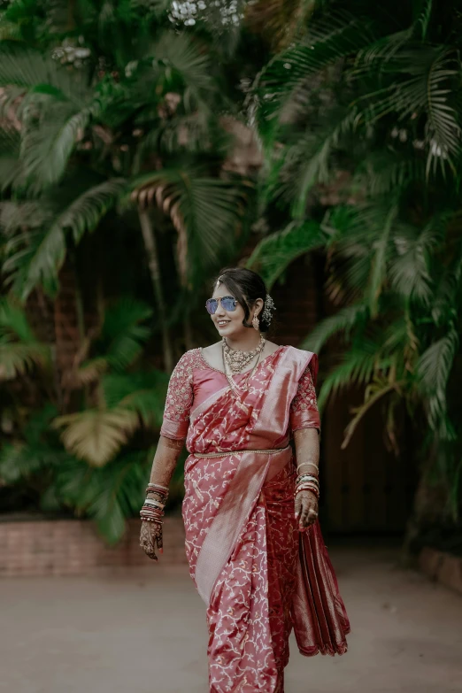 a woman with glasses walks down the street