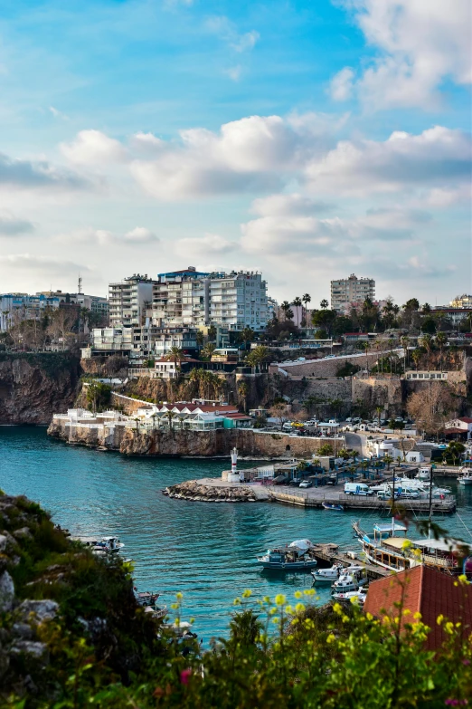 several boats are anchored in a bay next to houses