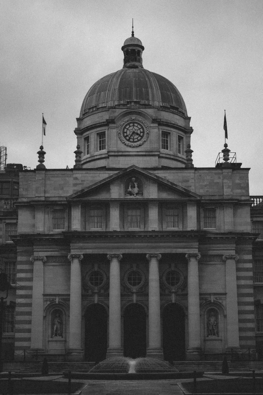 an old building with columns and a clock on it