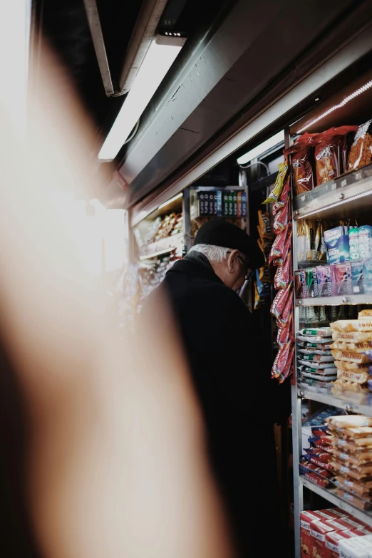 a man browsing through a grocery store's shelves