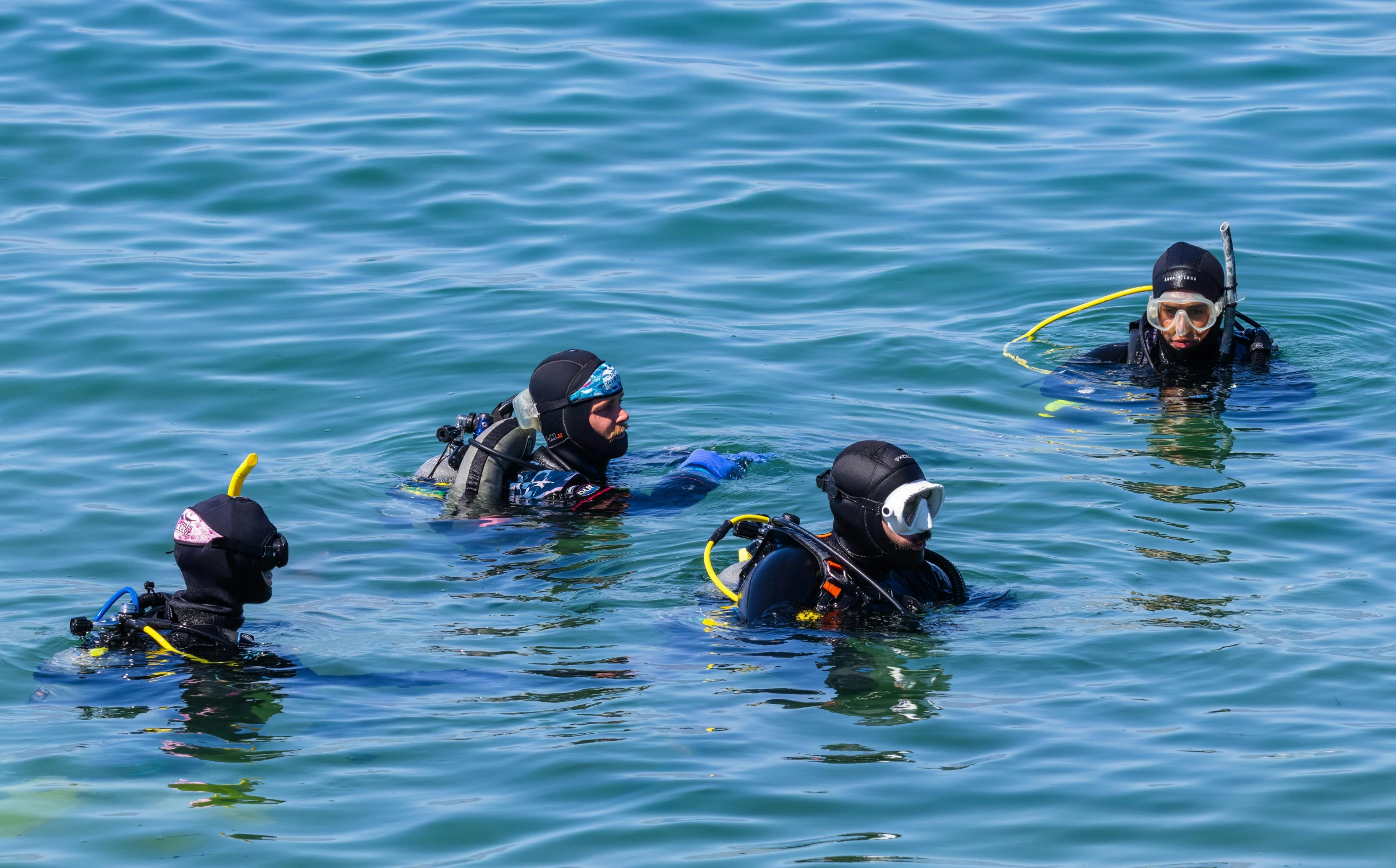 several people who are in the water with masks