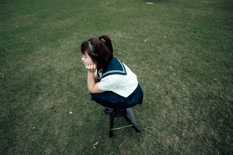 a young lady is sitting on top of a stool