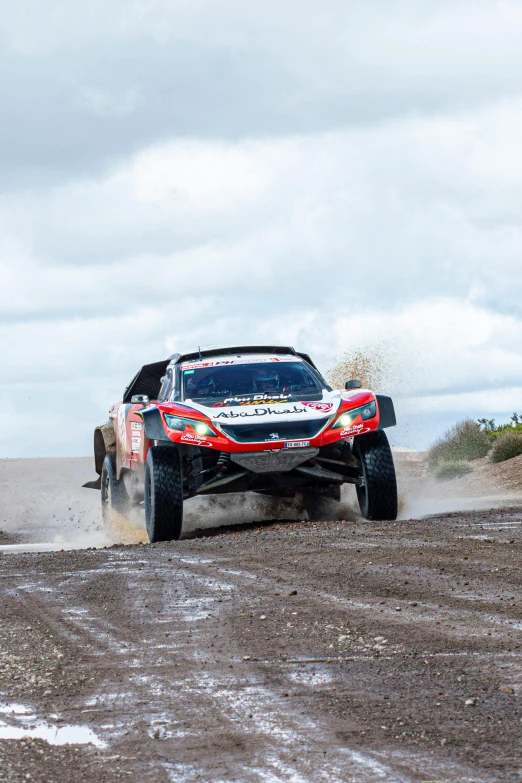 the suv is driving on muddy roads around an obstacle course