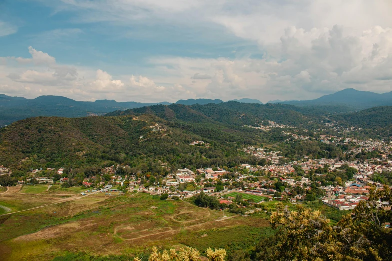 a hill with a town below the hills in a city