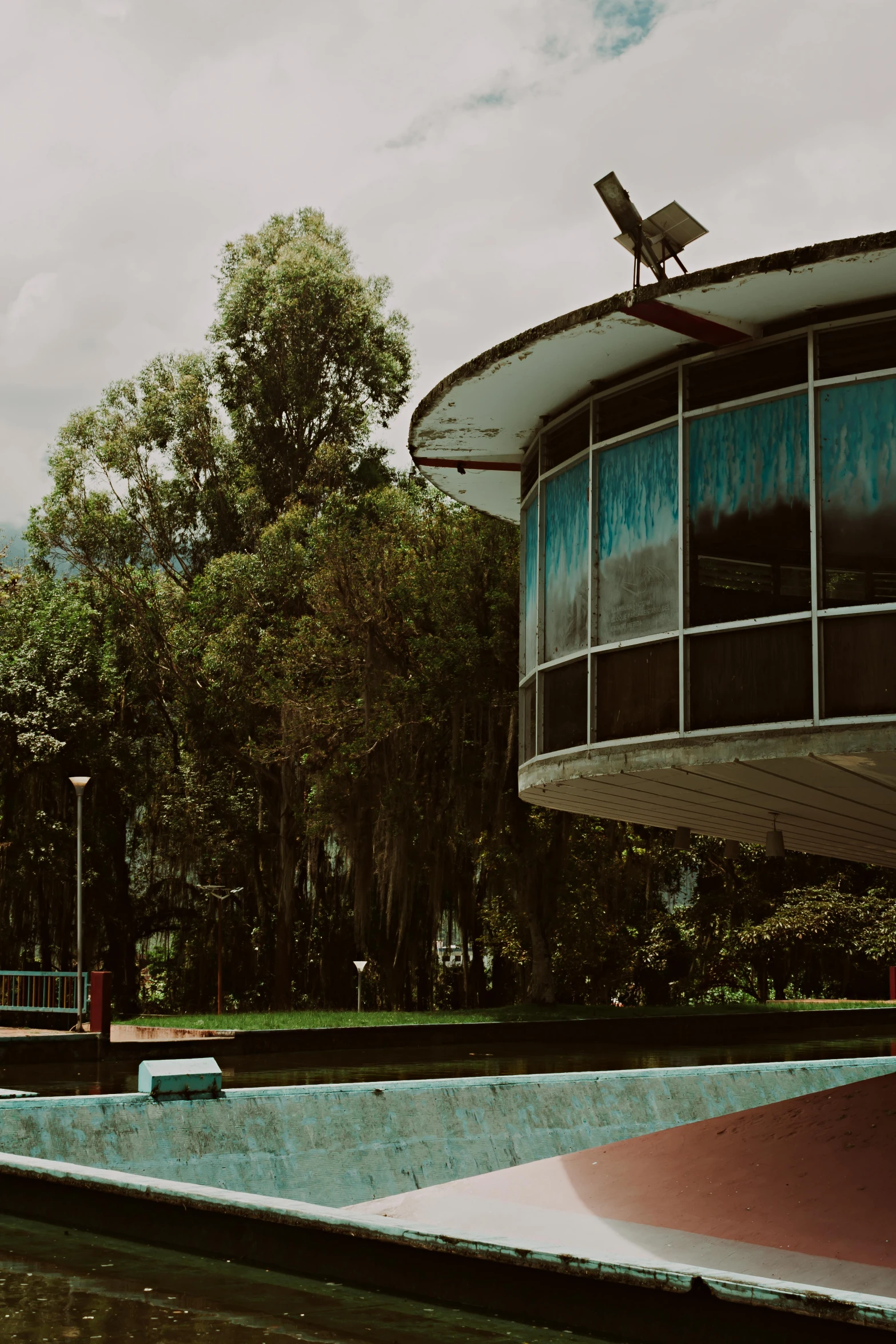 a skate park on a cloudy day with a bird on top