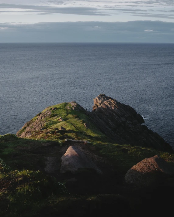 a very large rocky outcrop near the ocean