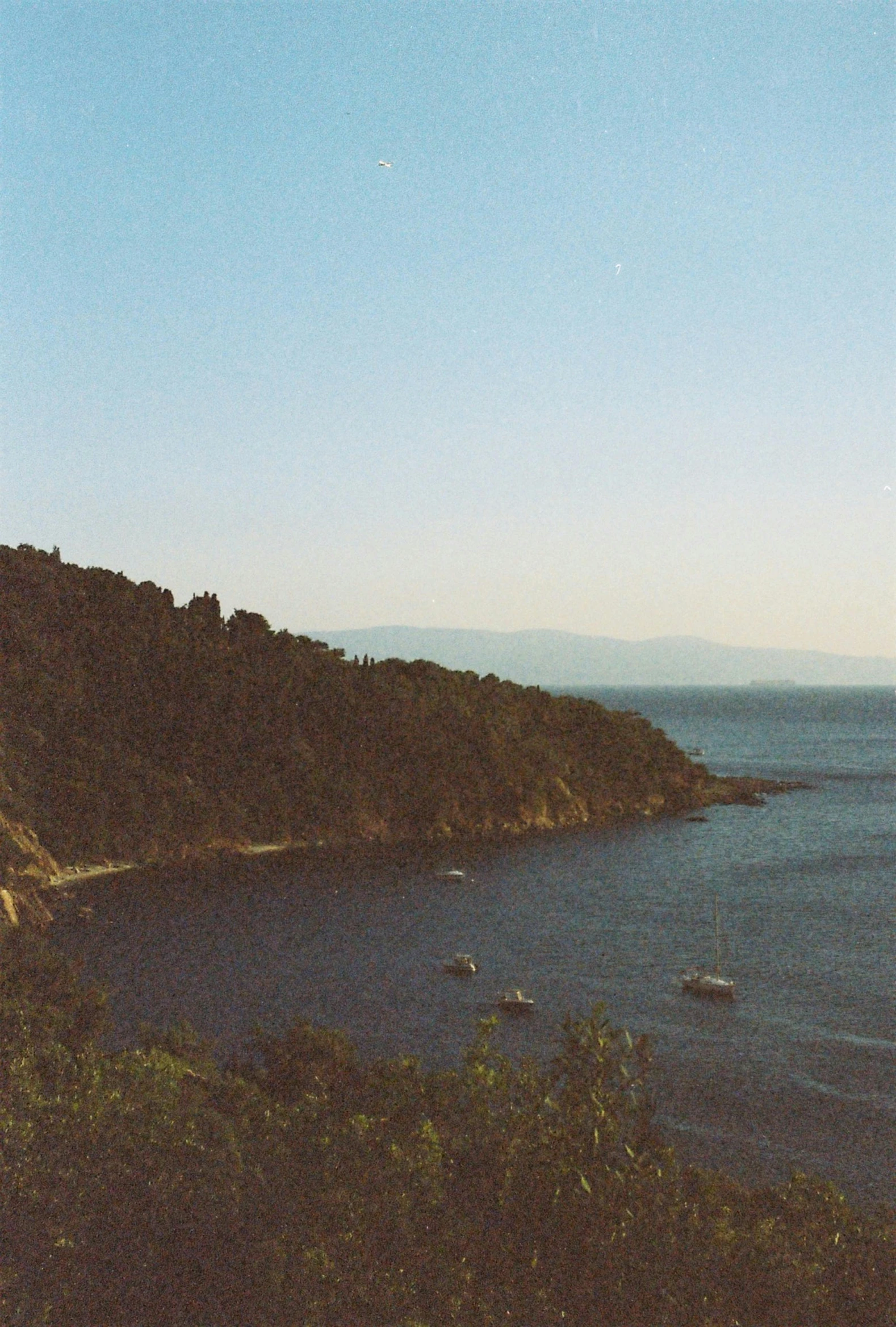 boats are sitting in the water near a mountain