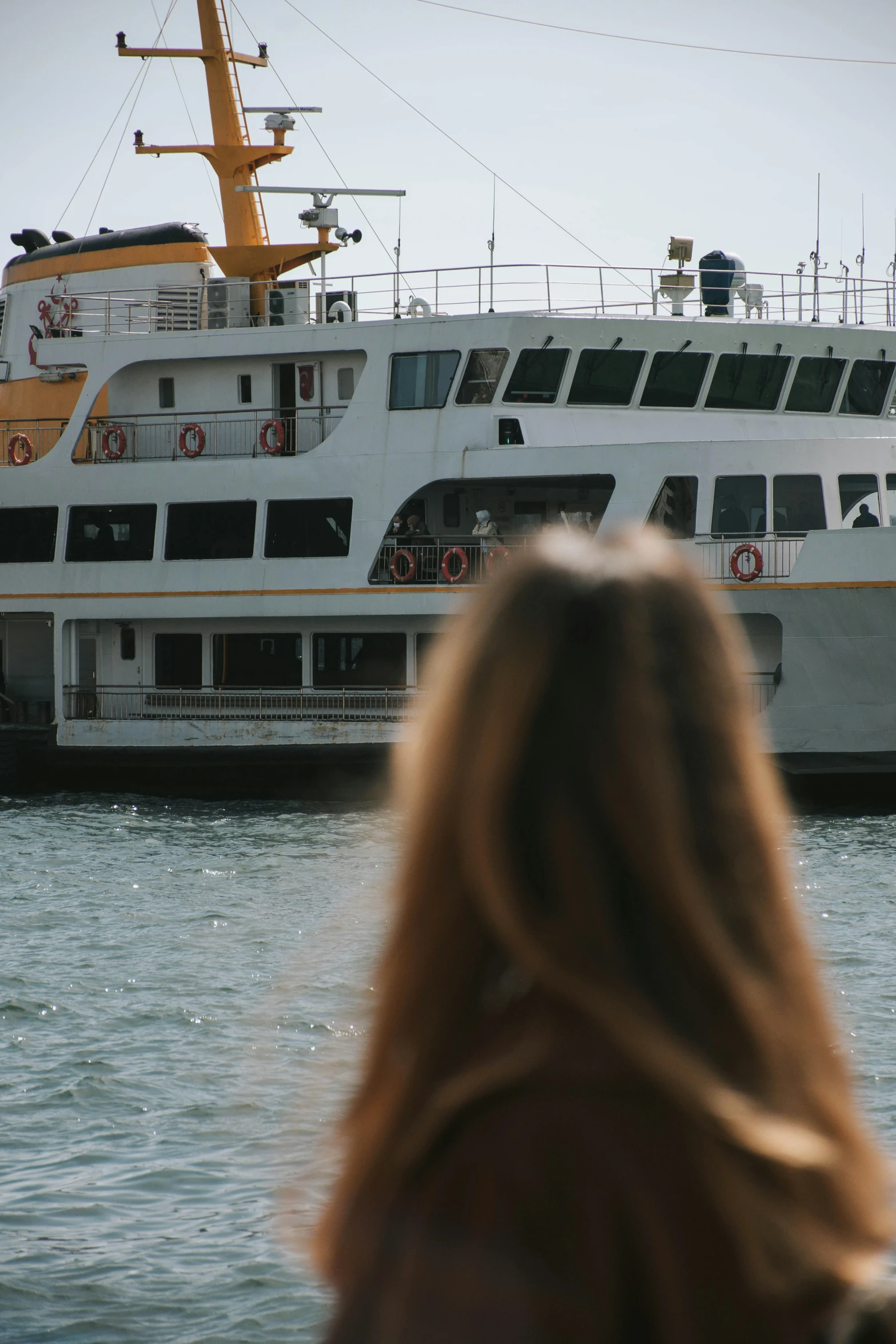 a large white ship docked next to the water