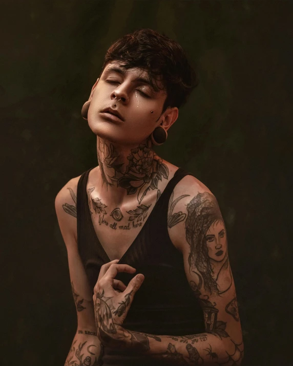 a man wearing tattoos is posing for the camera