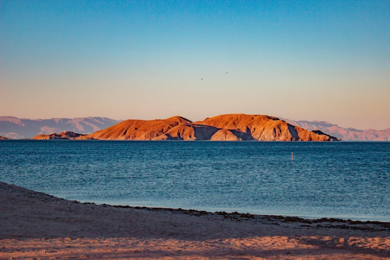 the water near land and mountains are blue