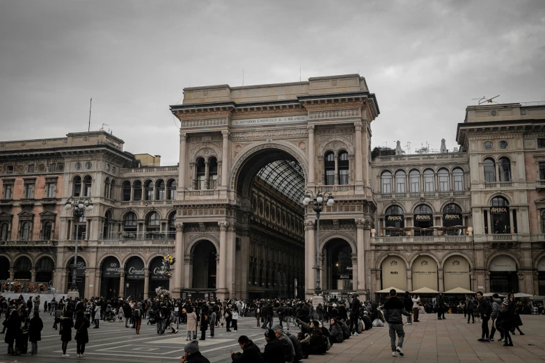 an ornate stone building with lots of people on it