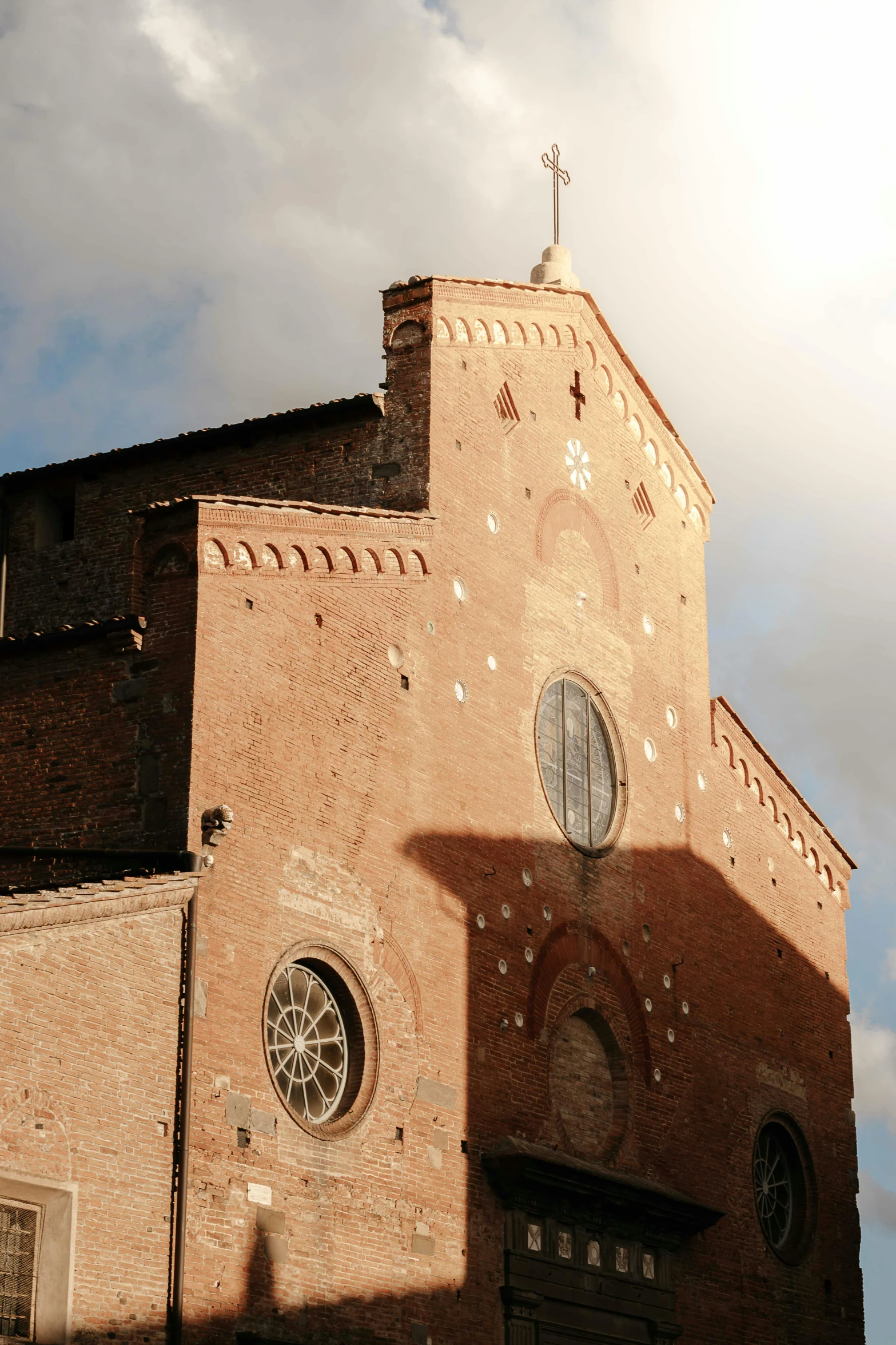 a church steeple and large window on a sunny day