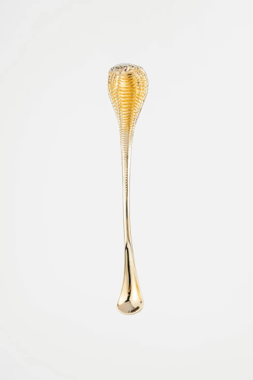 the gold spoon has an elegant design in it