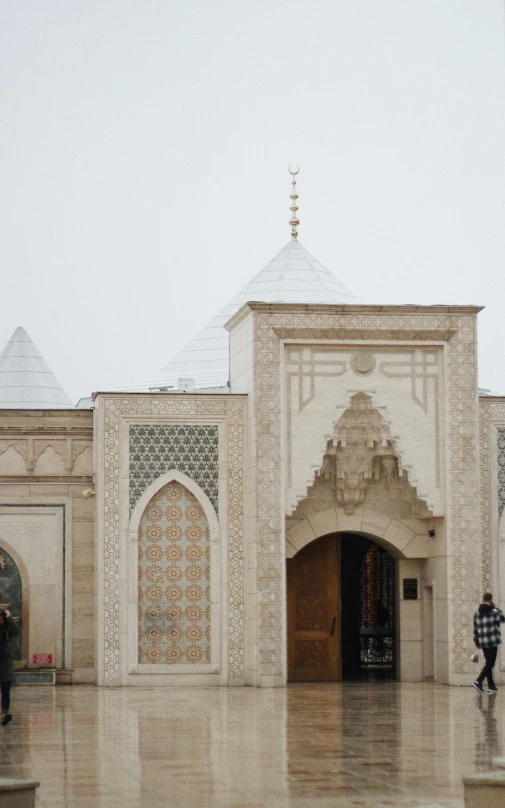 an image of a man standing in front of the entrance to a building