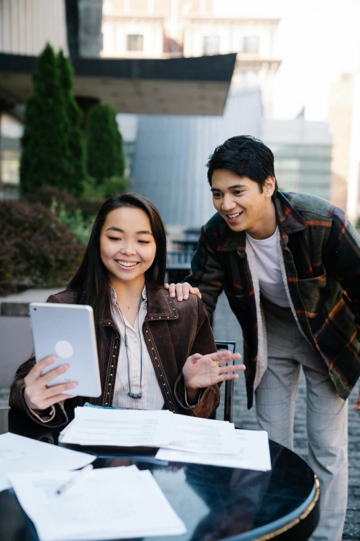 there are two people looking at an electronic screen