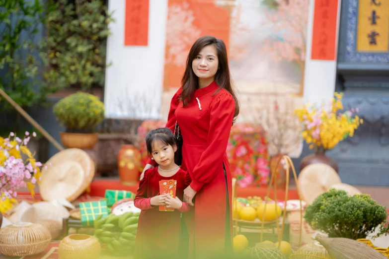 a mother and daughter standing in front of different pots