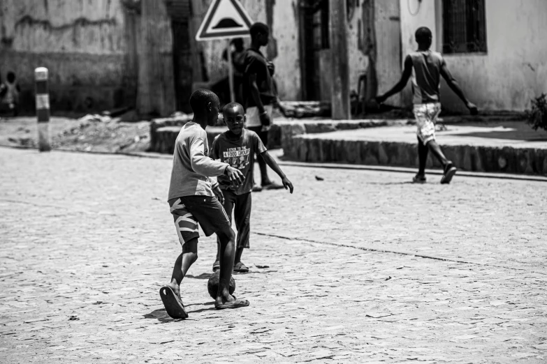 s playing with a soccer ball in the city