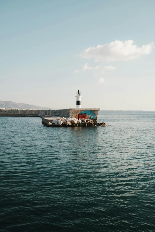 a view of some water with a lighthouse in the middle