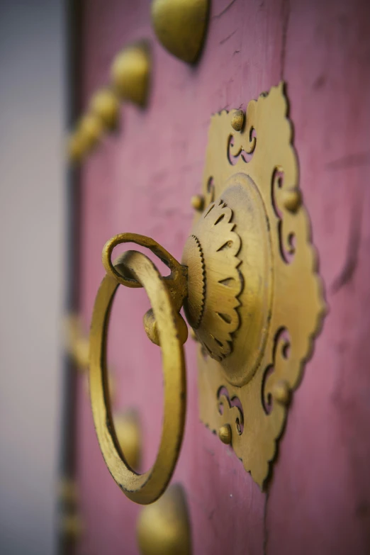 there is a large golden ring mounted to the wall