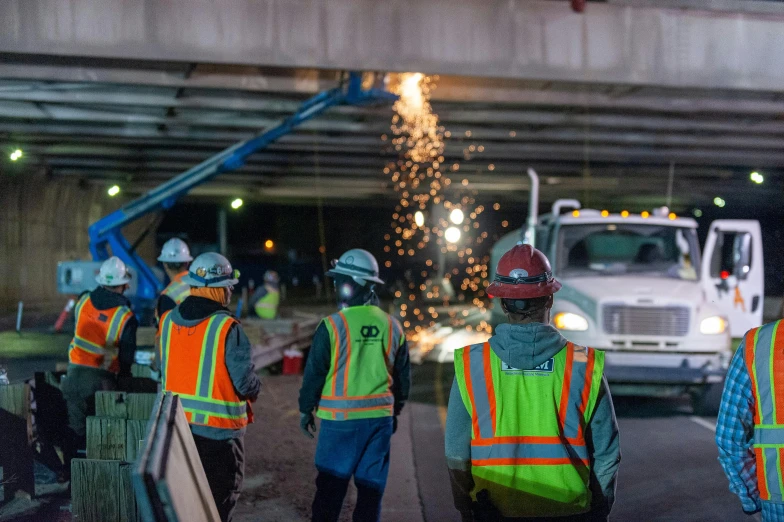 a bunch of workers walking down a street