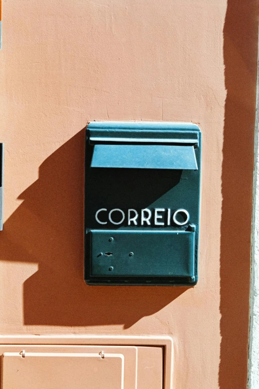 the blue and white mailbox on the side of a building