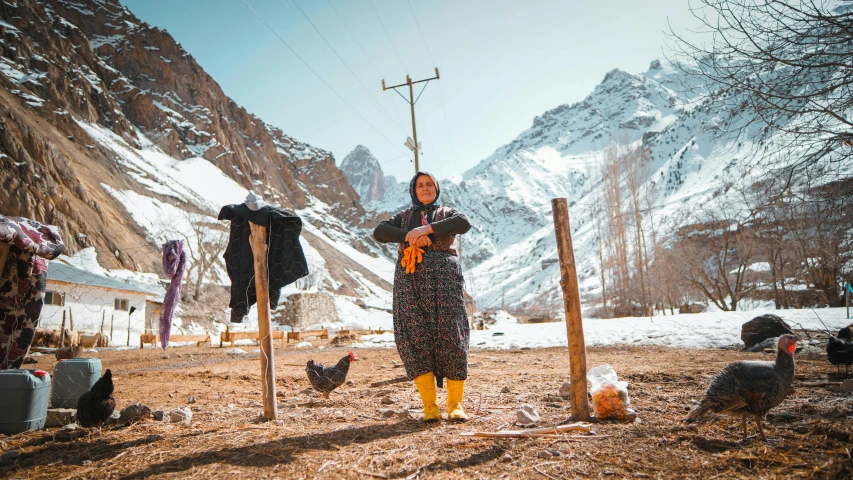 a woman is looking through her binoculars in the mountains