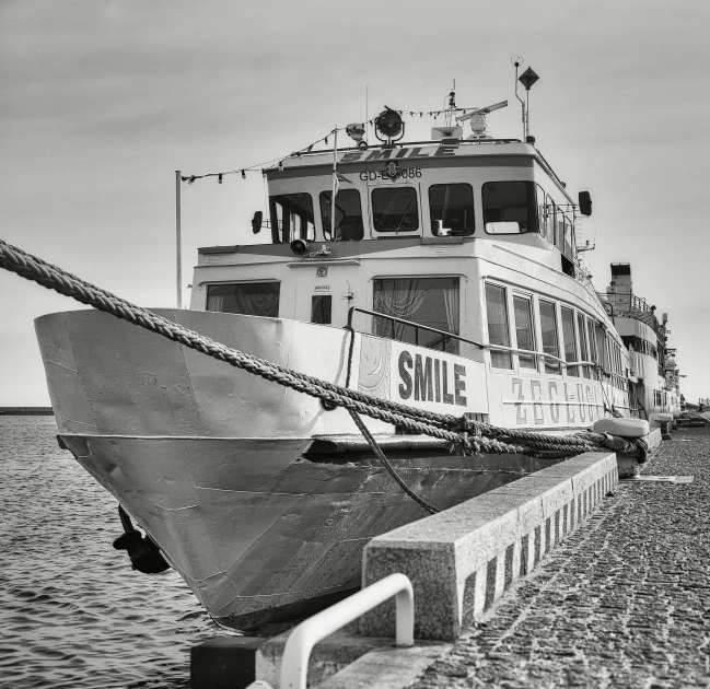 black and white po of a ship docked at the shore