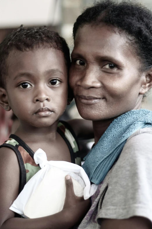 a woman holding a child on her arms