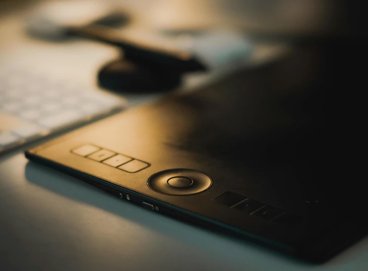 a closeup s of a cell phone, keyboard, and mouse