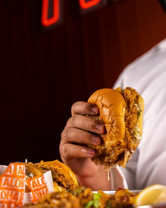 a hand holding a fried chicken sandwich