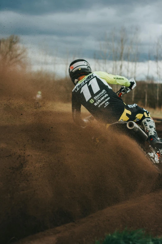 an athlete in full gear riding through a brown and green field