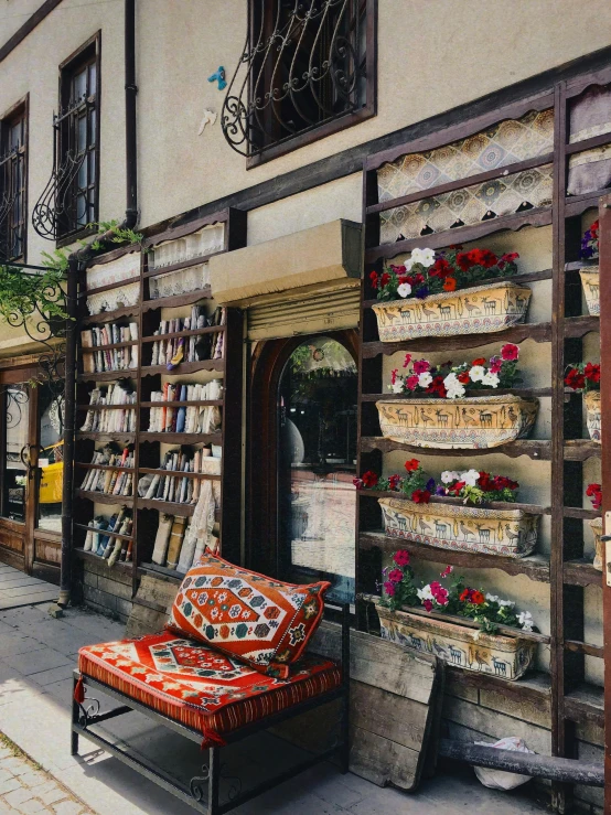 a large brown book stand sitting outside a building