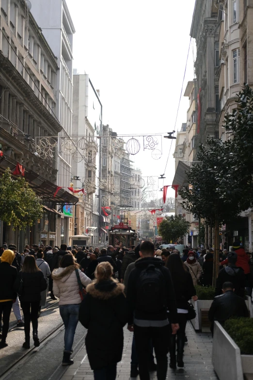 a very large group of people walk through the streets