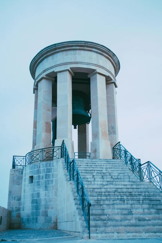 stairs lead up to the tower with an outdoor bell