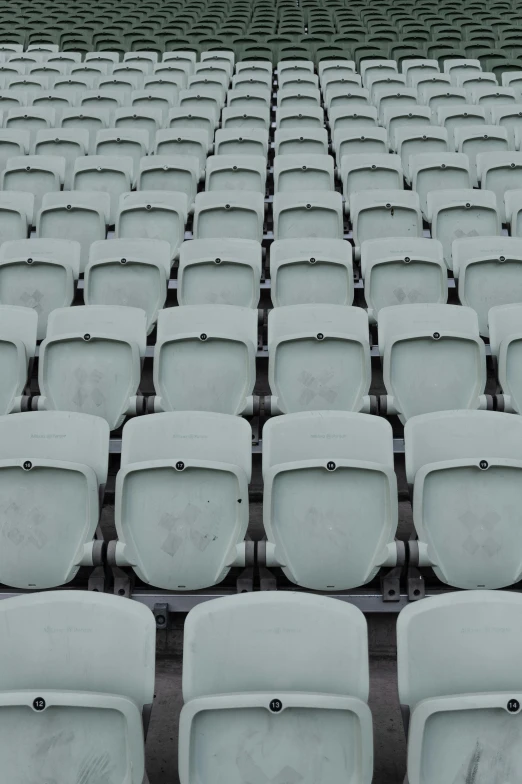 many chairs in rows, all without one in the seat