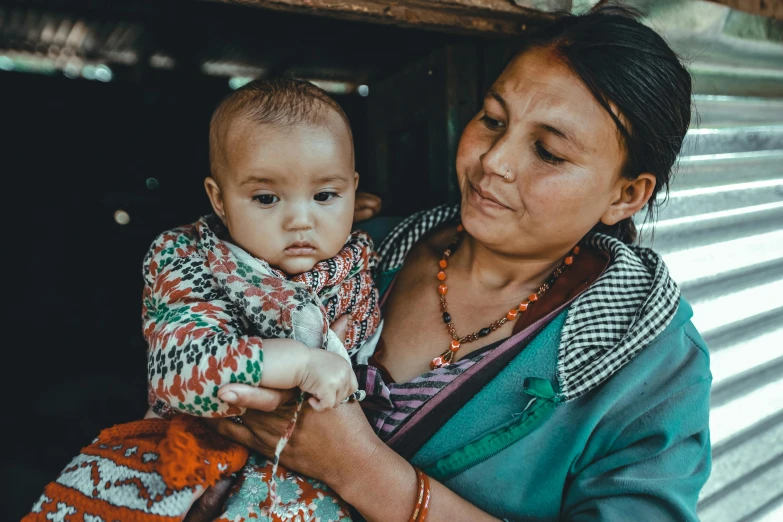 a woman holding a child while they are looking at soing