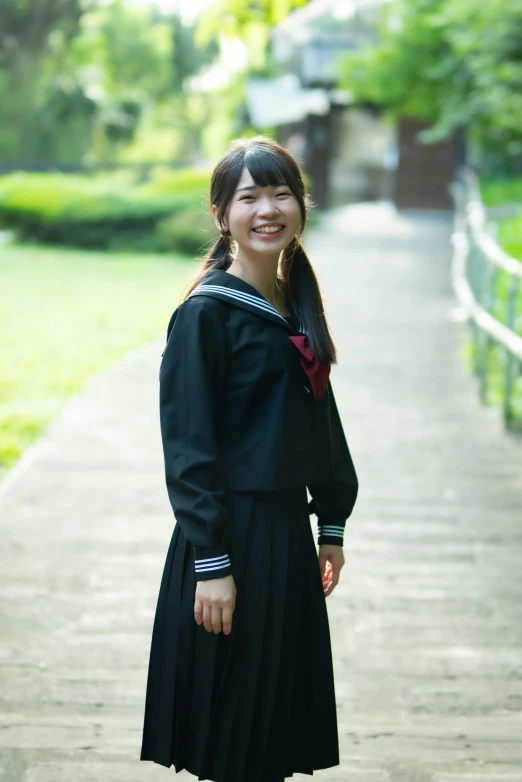 a woman dressed in a sailor's uniform poses for a po