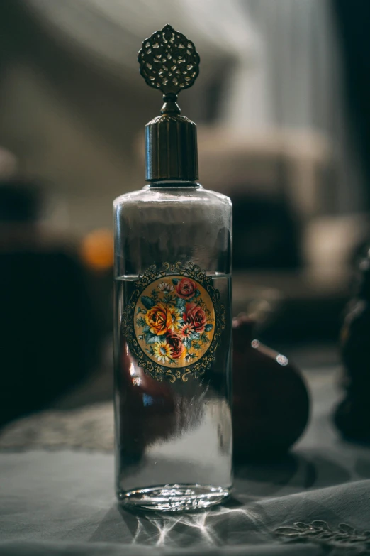 an empty glass bottle is seen on the table