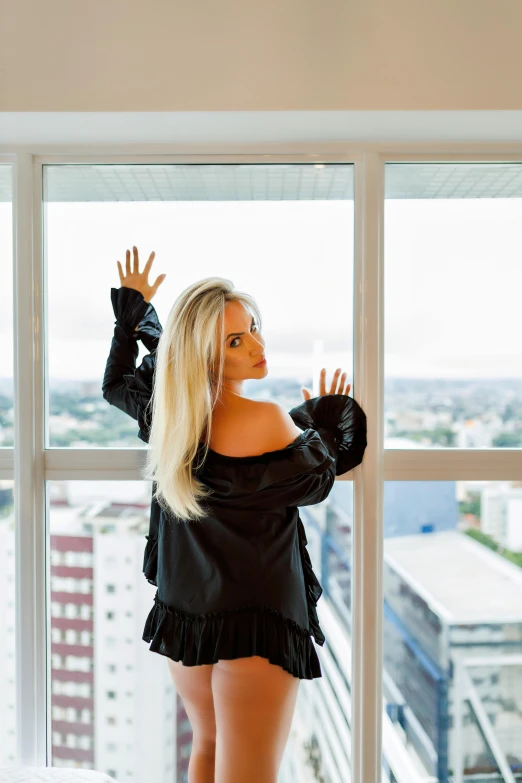 a woman standing on a window ledge