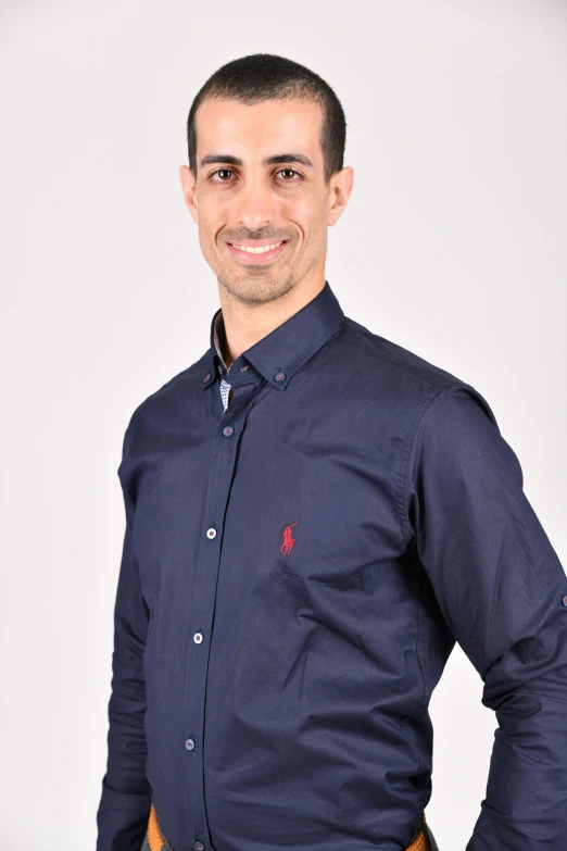 a man in dress clothes posing for a picture
