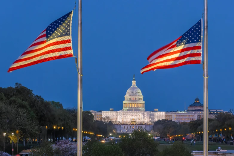 three american flags blowing in the wind