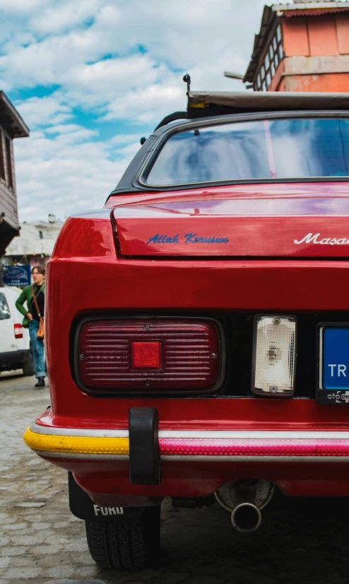 the rear view of a red sports car with a license plate