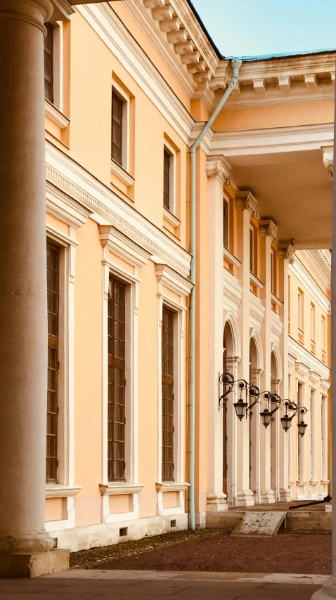 the view of a building with columns and a clock on the front of it