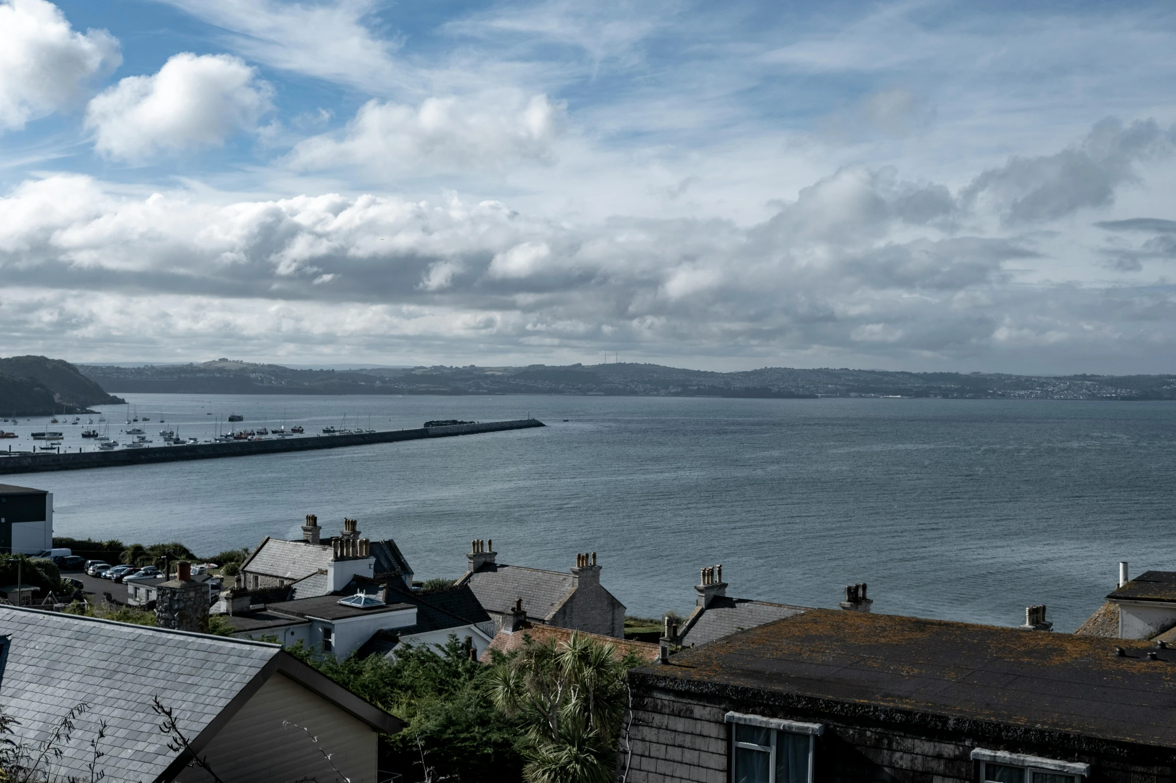 there is a blue sky and clouds over the ocean